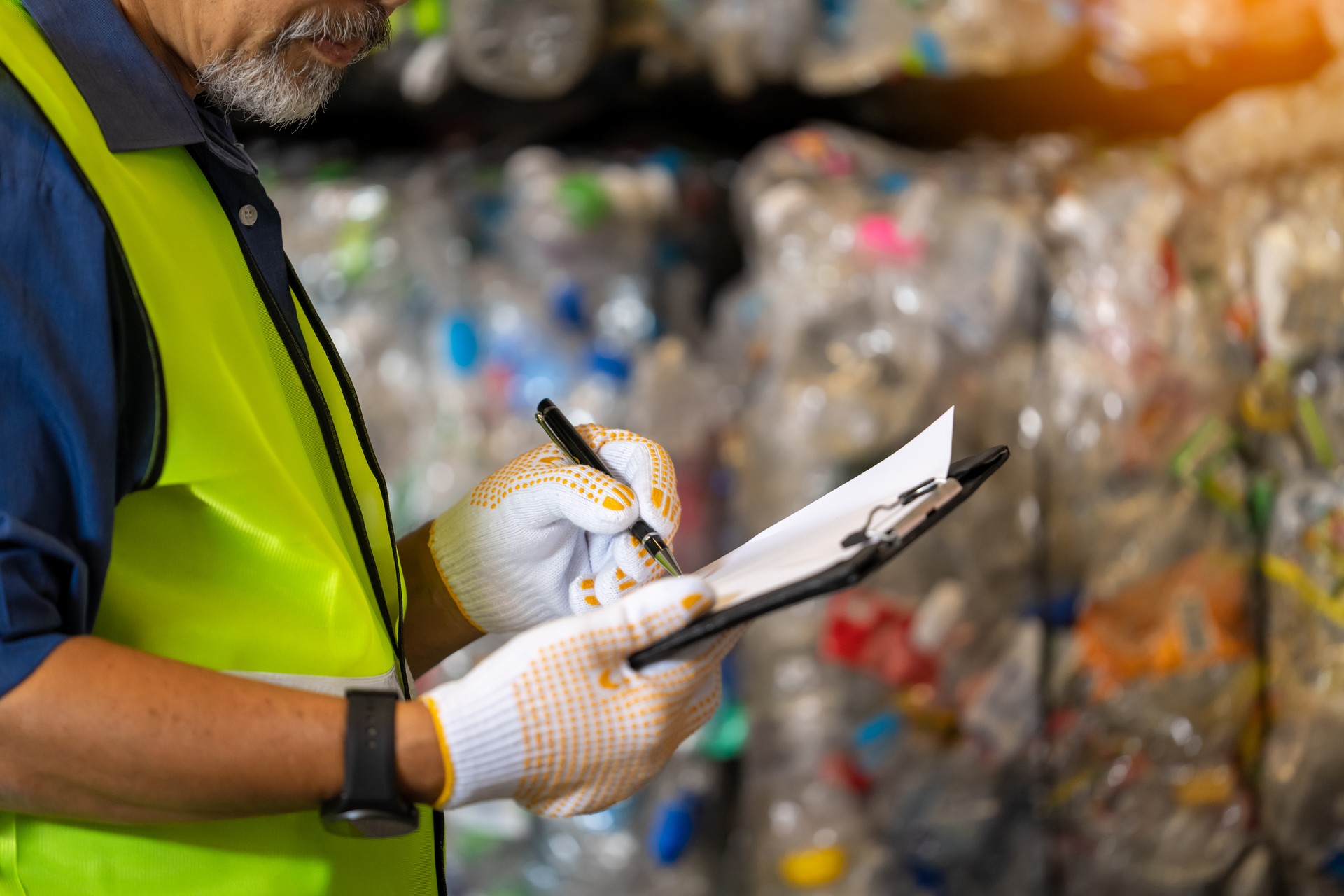 Foreman to check the stock and control the separation of recyclable waste of the plastic waste recycling plant. And other types of waste, the concept of recycling.