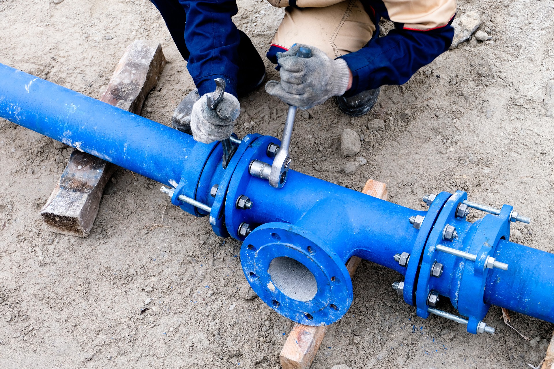 Workers installing water supply pipeline system, close up